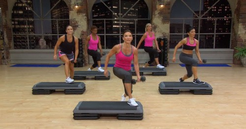 cathe friedrich doing a lunge with a dumbbell on the step
