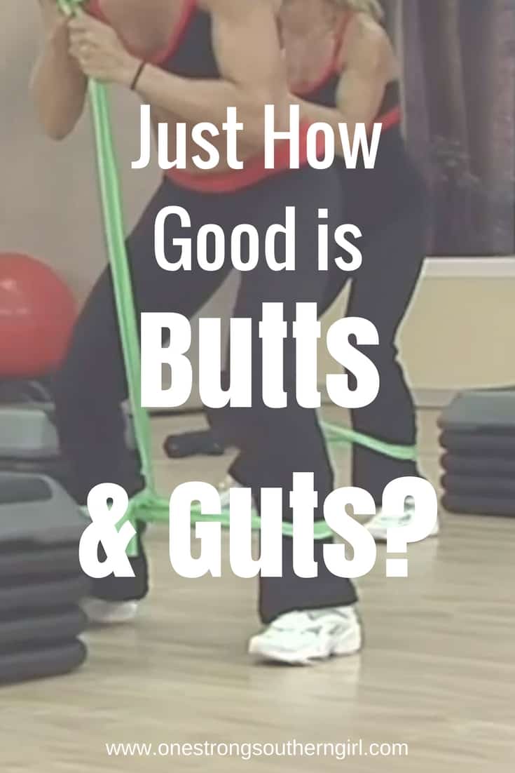 Cathe Friedrich in the Butts and Guts video doing a squat with a long exercise band around her ankles