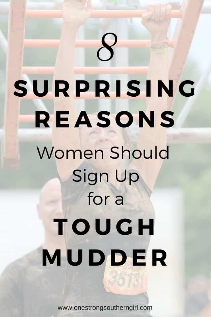 a girl doing the monkey bars in the Tough Mudder